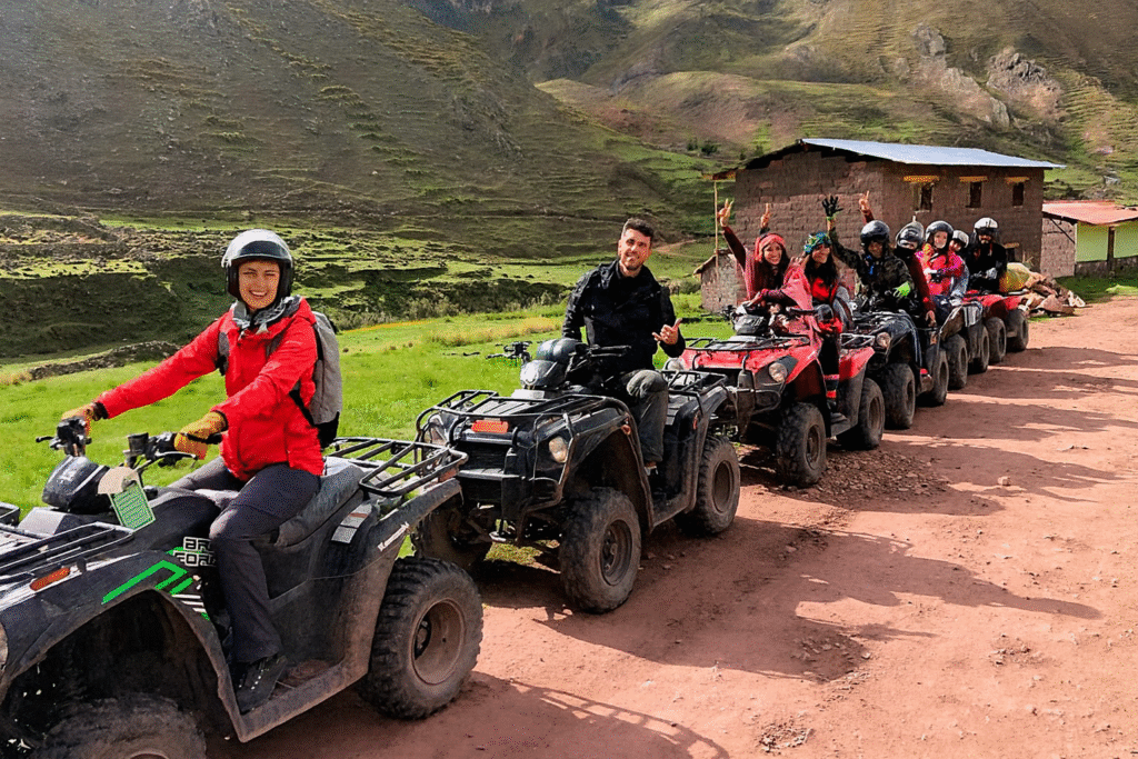 Group of tourists driving ATVs through Andean valleys toward Rainbow Mountain