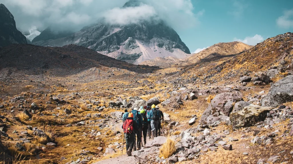 Group of hikers trekking across a high mountain pass during the Ausangate Trek in Peru