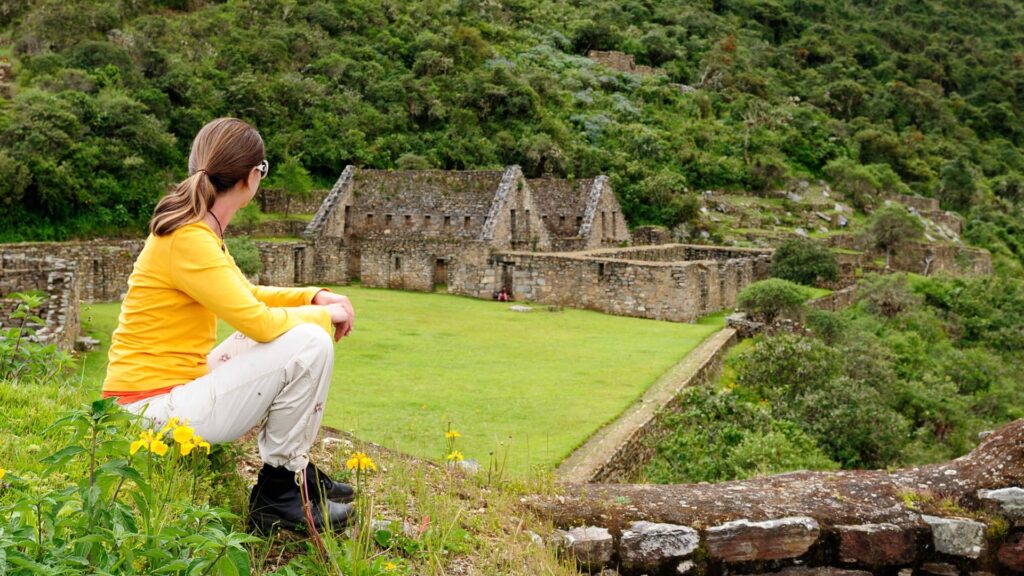 Traveler admiring the ancient ruins of Choquequirao surrounded by lush mountains on the 5-day classic trek