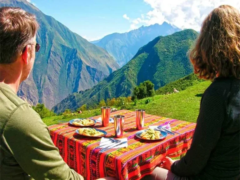 Hikers exploring the Choquequirao Inca ruins surrounded by mountains during the Choquequirao treks in Peru.