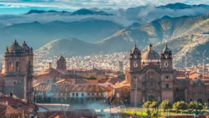 Panoramic view of Cusco historic center with cathedral, colonial architecture and Andean mountains