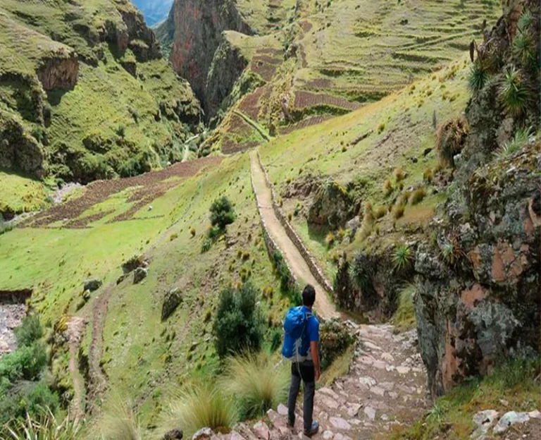 Hiker walking the Huchuy Qosqo Inca Trail on a 4-day trek to Machu Picchu