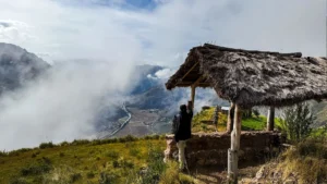 Traveler enjoying panoramic Sacred Valley views from Huchuy Qosqo viewpoint near Cusco, Peru.