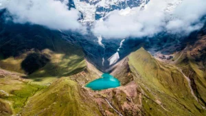 Aerial view of Humantay Lake with turquoise waters and snow-capped mountains in Peru
