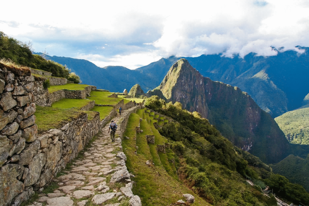 Travelers arriving at Inti Punku, the Sun Gate, after hiking the Short Inca Trail with Pacha Perú Explorers
