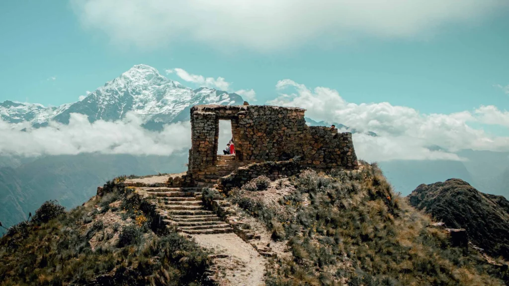 View of Intipunku Sun Gate in Ollantaytambo with mountains in the background, Cusco Peru.