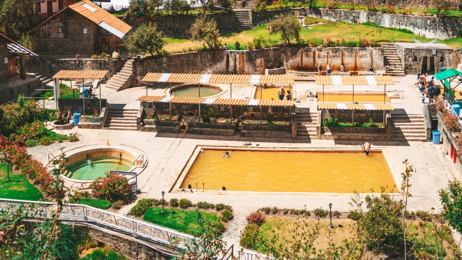 Hikers relaxing in natural hot springs on the Lares Trek in Peru