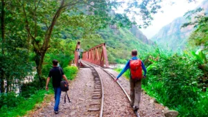 Travelers walking along the Hidroelectrica railway on the Machu Picchu by Car route