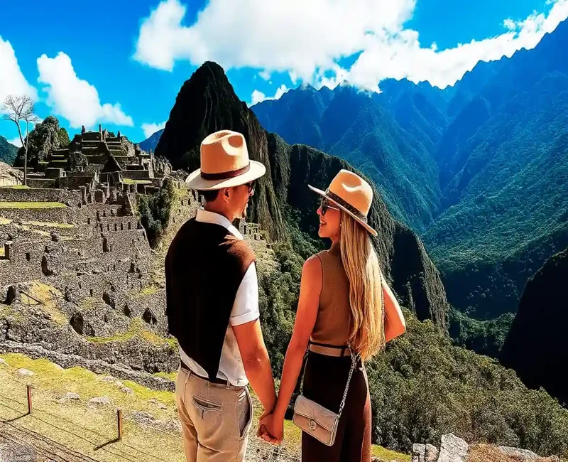 Couple enjoying a guided tour at Machu Picchu with panoramic mountain views