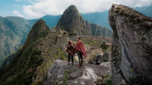 Couple enjoying panoramic views of Machu Picchu and Huayna Picchu