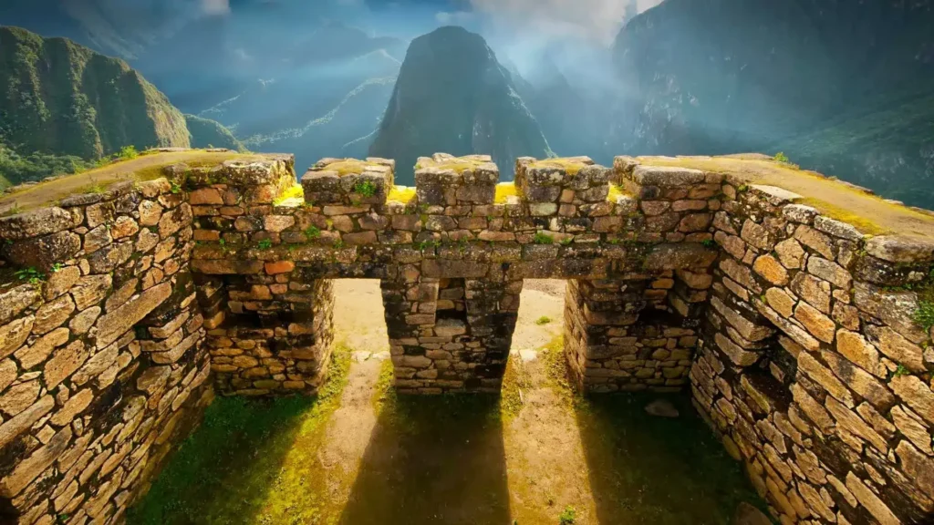 Inca stone walls overlooking Machu Picchu with Huayna Picchu mountain in the background