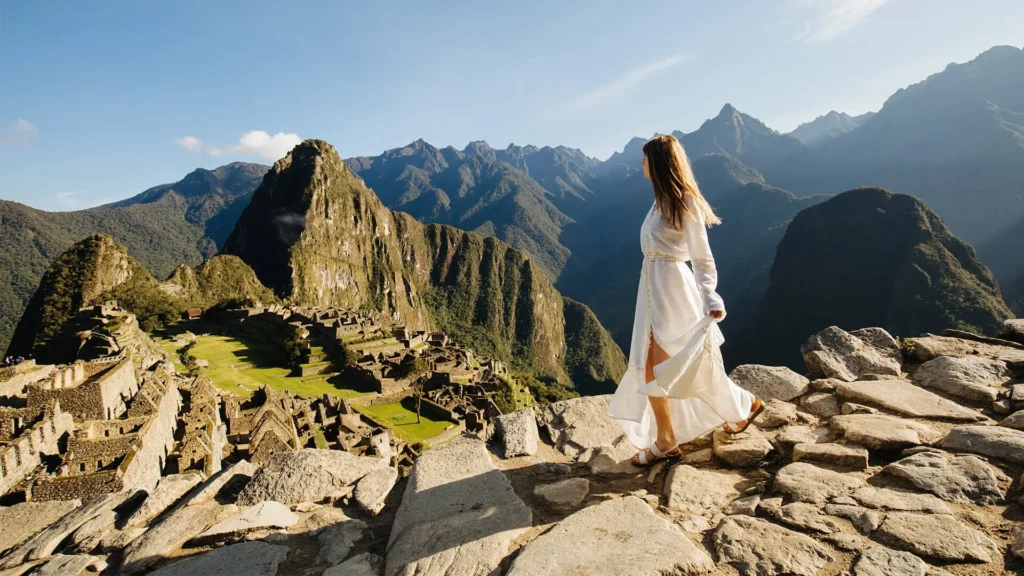 Woman enjoying a luxury Machu Picchu tour with panoramic Andean mountain views – Pacha Peru Explorers