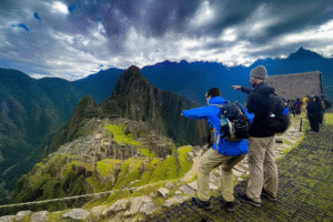 Travelers admiring Machu Picchu at sunrise after completing the Short Inca Trail to Machu Picchu with Pacha Perú Explorers