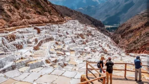 Travelers visiting the Maras salt mines in the Sacred Valley of Peru