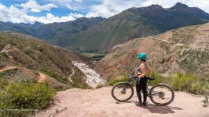 Cyclist overlooking the Maras Salt Mines in the Sacred Valley near Cusco, Peru.