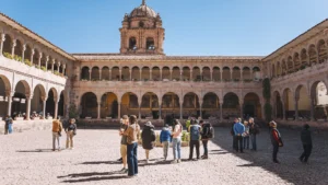 Visitors exploring Qorikancha Temple courtyard during a Cusco City Tour in Peru.
