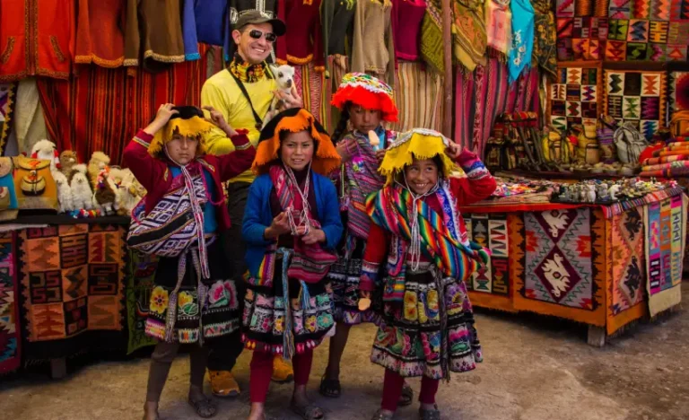 Andean children wearing traditional clothing at Pisac Market in the Sacred Valley, Cusco Peru