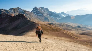 Woman hiking in the Andes near Rainbow Mountain in Peru with mountain scenery