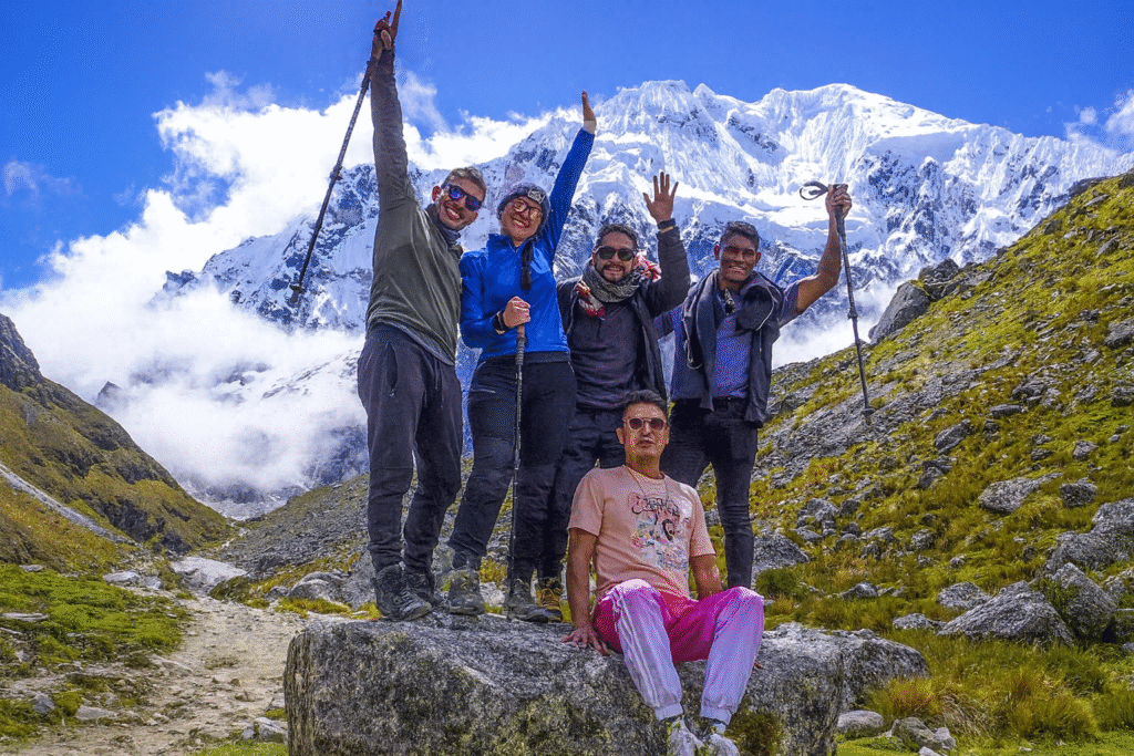 Group of hikers celebrating on the Salkantay Trek Challenge 3 Days with snowy Salkantay peak in the background