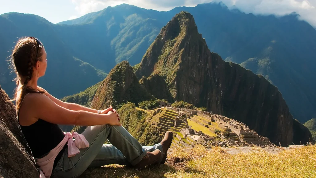 Traveler watching the sunrise over Machu Picchu after completing the Short Inca Trail 2 Days with Camping.
