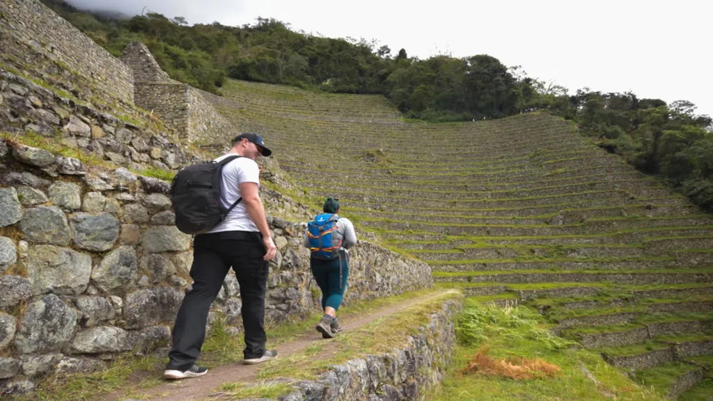 Hikers exploring the Wiñay Wayna ruins on the Short Inca Trail 2 Days with Camping.