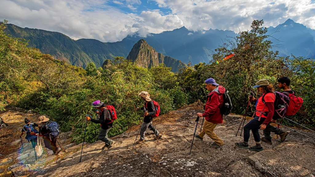 Hikers trekking the Short Inca Trail with Machu Picchu mountains in the background