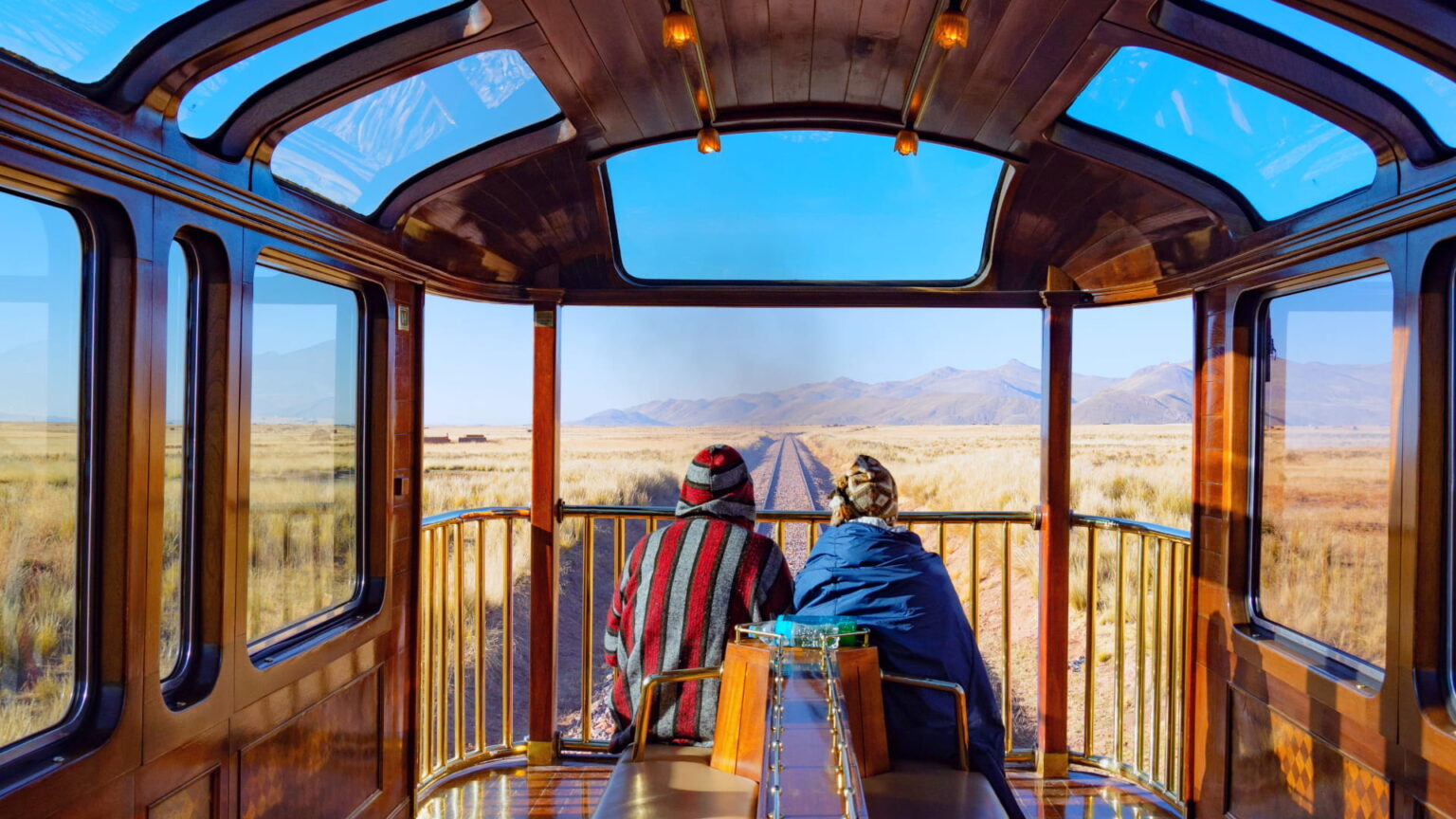 Passengers enjoying panoramic views from the Vistadome train traveling through the Andes toward Machu Picchu