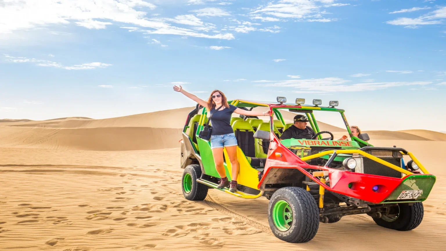 Tourist enjoying dune buggy ride in Huacachina desert Ica Peru with sand dunes landscape