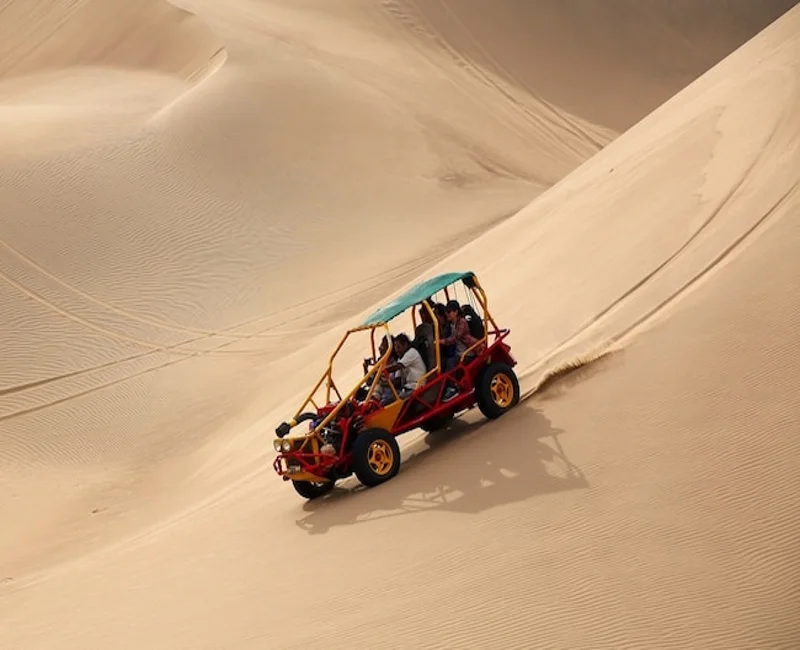 Dune buggy driving down sand dunes in Huacachina desert in Ica Peru