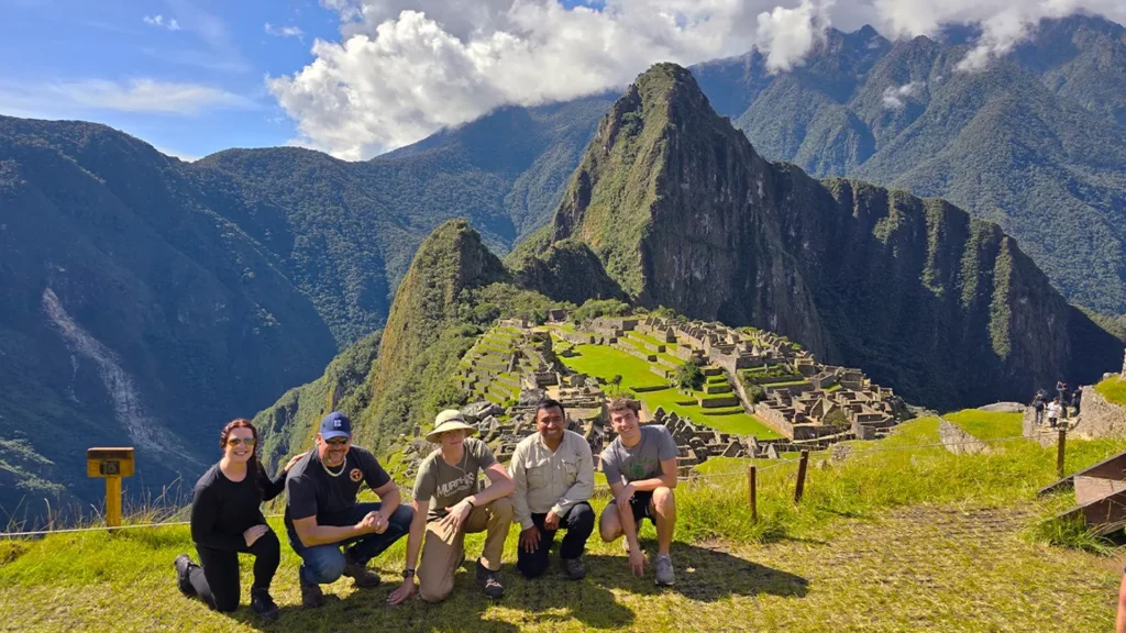 Tourists enjoying the view of Machu Picchu citadel and Huayna Picchu mountain during the best time to visit Machu Picchu Peru
